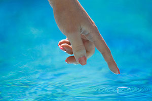 Hand touching water